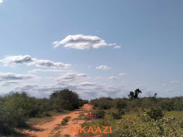 Prime 6-acre road frontage land for sale in Baolala with direct tarmac frontage, water and electricity on site, freehold title, ideal for commercial, residential, or agricultural investment.