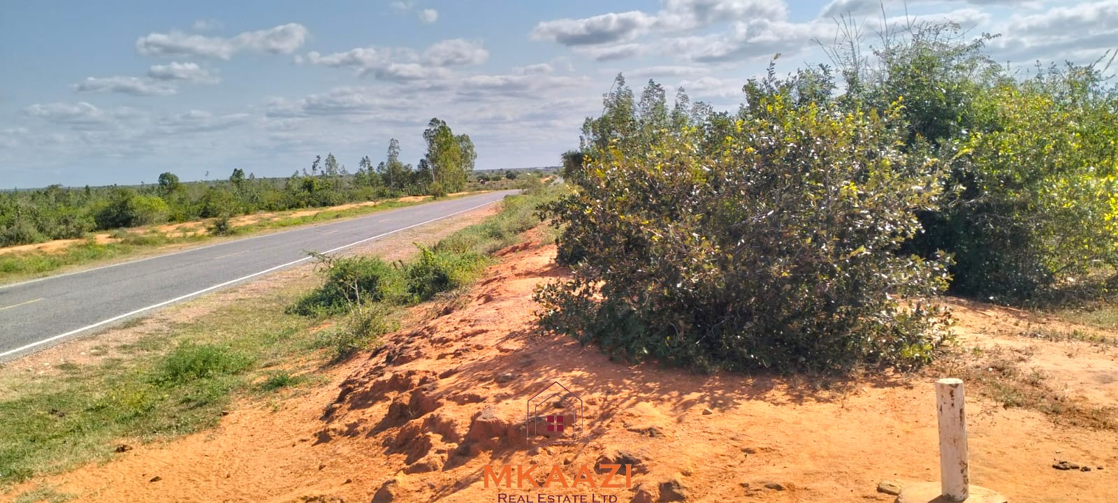 Prime 6-acre road frontage land for sale in Baolala with direct tarmac frontage, water and electricity on site, freehold title, ideal for commercial, residential, or agricultural investment.