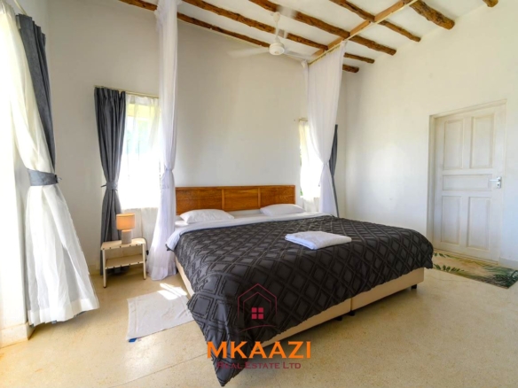 Fully furnished 4-bedroom riverside holiday house accommodating up to 10 guests with hippo views, spacious compound, and fully equipped kitchen.