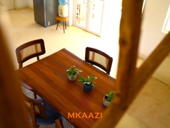 Fully furnished 4-bedroom riverside holiday house accommodating up to 10 guests with hippo views, spacious compound, and fully equipped kitchen.