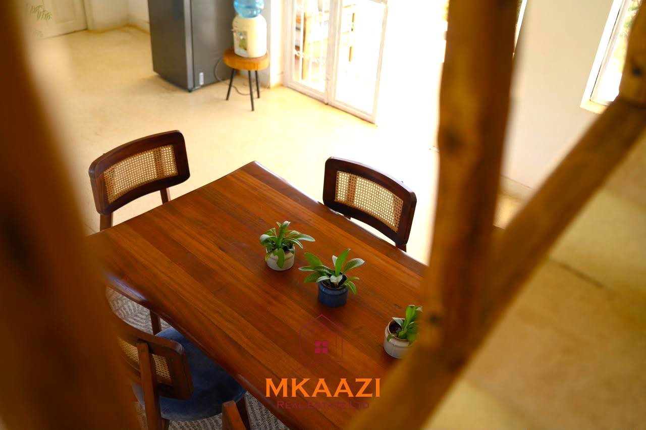 Fully furnished 4-bedroom riverside holiday house accommodating up to 10 guests with hippo views, spacious compound, and fully equipped kitchen.