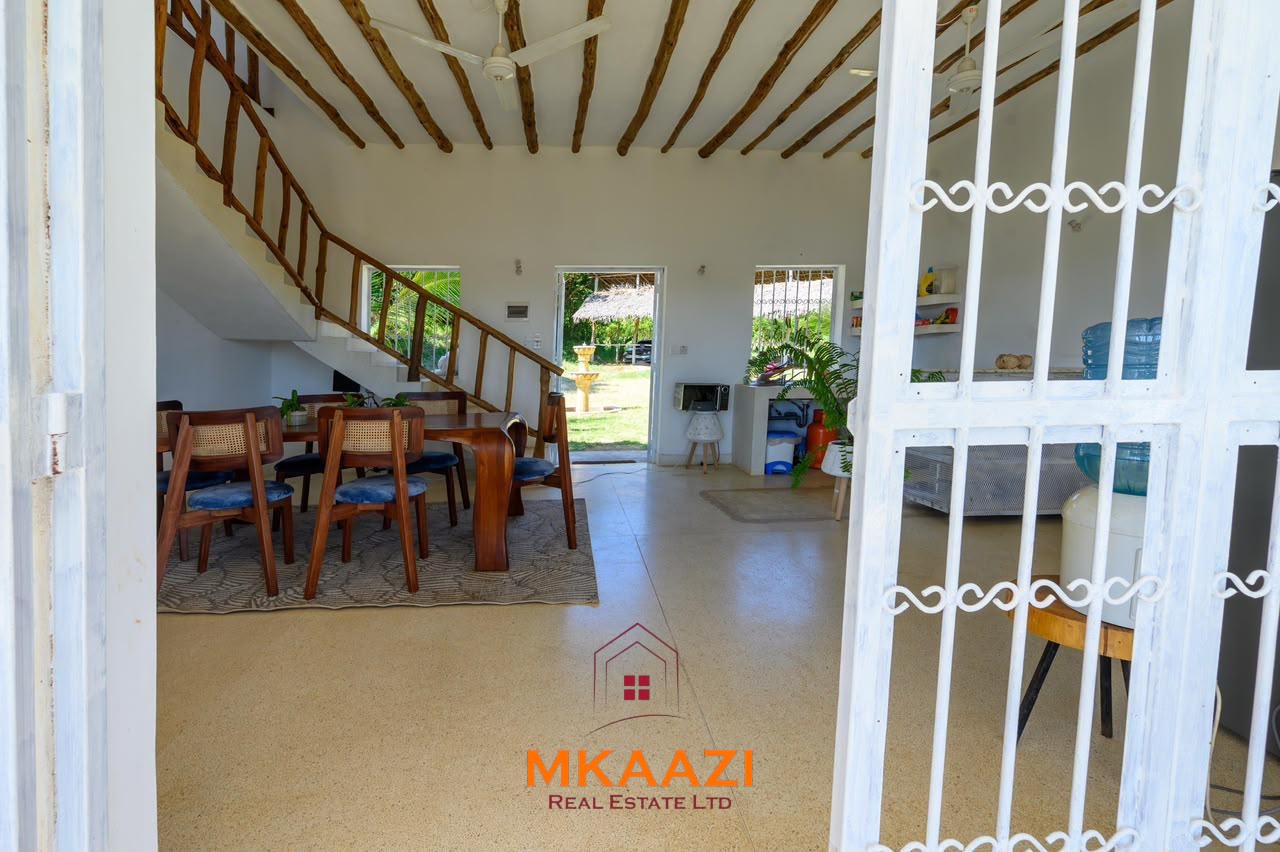 Fully furnished 4-bedroom riverside holiday house accommodating up to 10 guests with hippo views, spacious compound, and fully equipped kitchen.