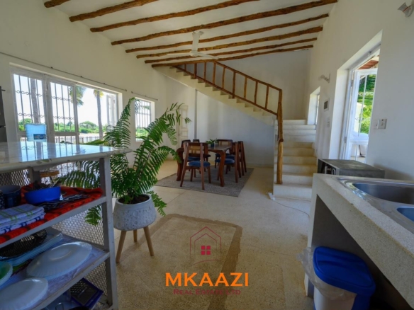 Fully furnished 4-bedroom riverside holiday house accommodating up to 10 guests with hippo views, spacious compound, and fully equipped kitchen.