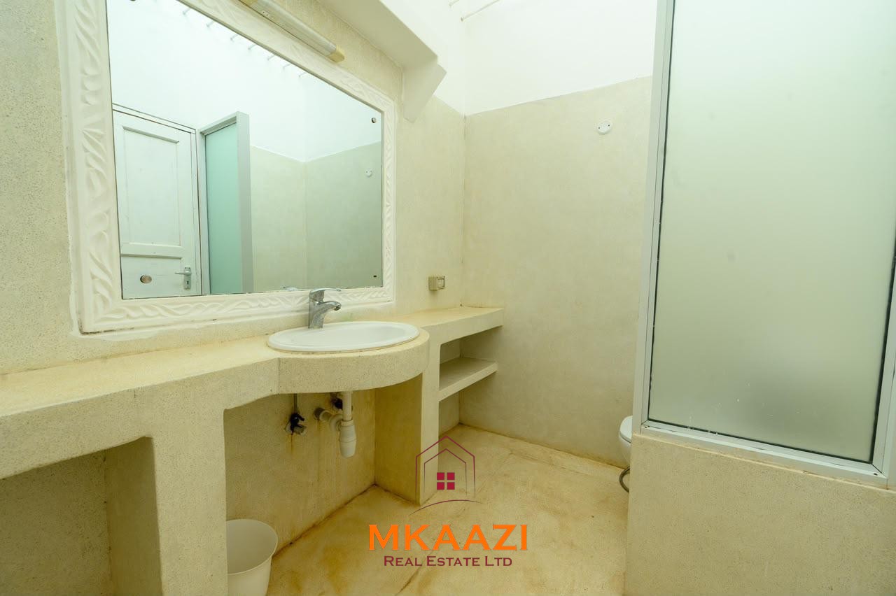 Fully furnished 4-bedroom riverside holiday house accommodating up to 10 guests with hippo views, spacious compound, and fully equipped kitchen.