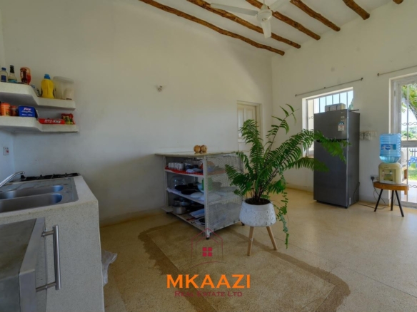 Fully furnished 4-bedroom riverside holiday house accommodating up to 10 guests with hippo views, spacious compound, and fully equipped kitchen.