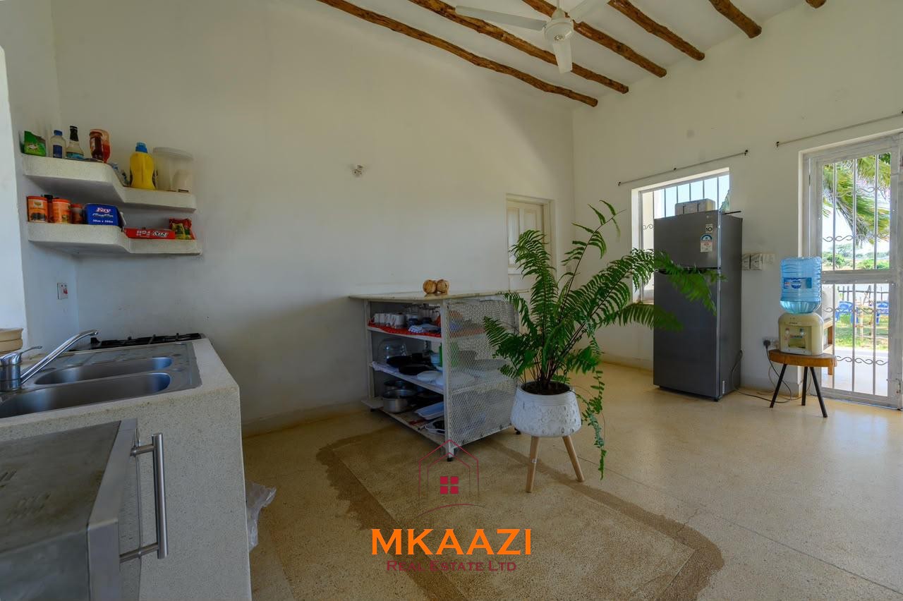 Fully furnished 4-bedroom riverside holiday house accommodating up to 10 guests with hippo views, spacious compound, and fully equipped kitchen.