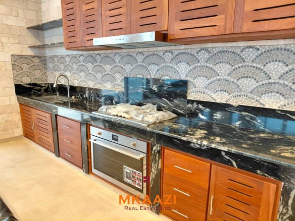 Luxury fully furnished 4-bedroom beachfront villa for sale in Love Island, Watamu with private pool, borehole, tropical gardens, and direct access to white sandy beaches.