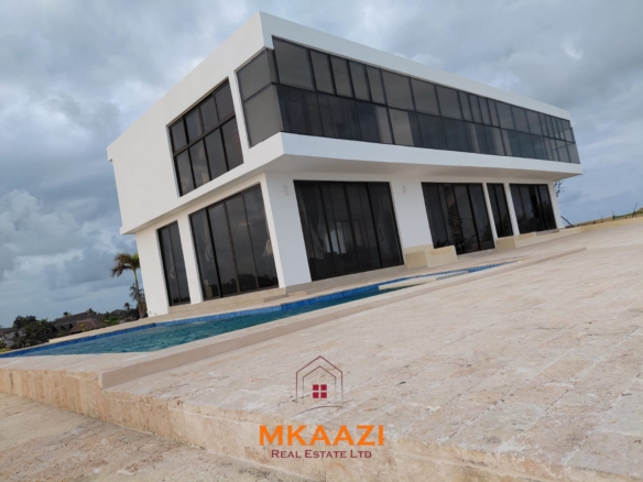 Luxury fully furnished 4-bedroom beachfront villa for sale in Love Island, Watamu with private pool, borehole, tropical gardens, and direct access to white sandy beaches.