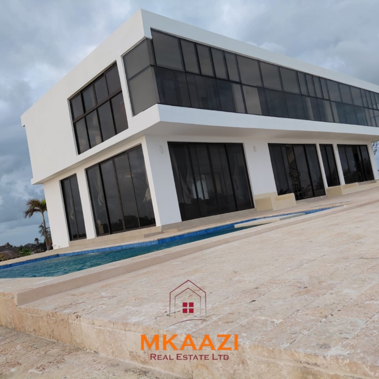 Luxury fully furnished 4-bedroom beachfront villa for sale in Love Island, Watamu with private pool, borehole, tropical gardens, and direct access to white sandy beaches.