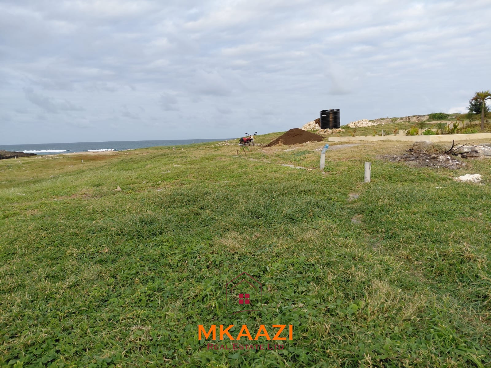 Luxury fully furnished 4-bedroom beachfront villa for sale in Love Island, Watamu with private pool, borehole, tropical gardens, and direct access to white sandy beaches.