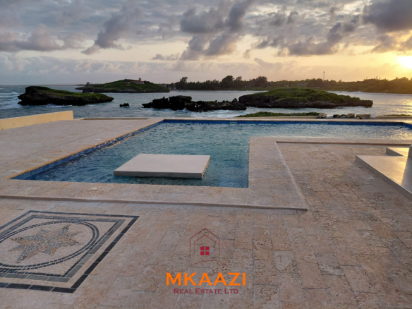 Luxury fully furnished 4-bedroom beachfront villa for sale in Love Island, Watamu with private pool, borehole, tropical gardens, and direct access to white sandy beaches.