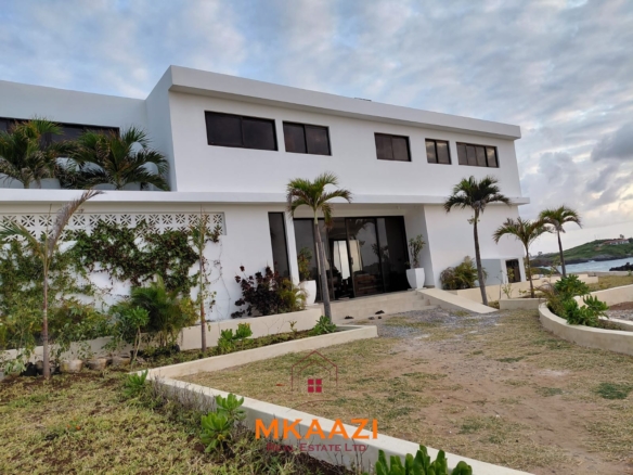 Luxury fully furnished 4-bedroom beachfront villa for sale in Love Island, Watamu with private pool, borehole, tropical gardens, and direct access to white sandy beaches.