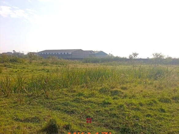 5-acre industrial-zoned land for sale in Thika Municipality with ready title deed, flat terrain, and easy access to major roads and utilities.