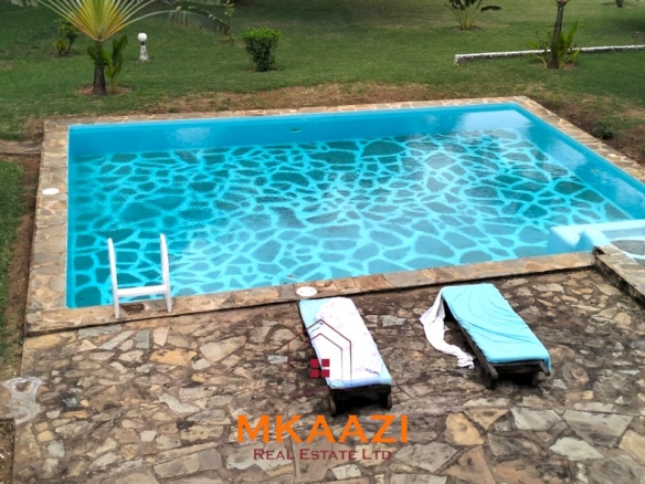 Elegant 4-bedroom all en-suite luxury villa with private swimming pool, landscaped one-acre garden, guest rooms, and entertainment area on Lamu Road, Malindi.