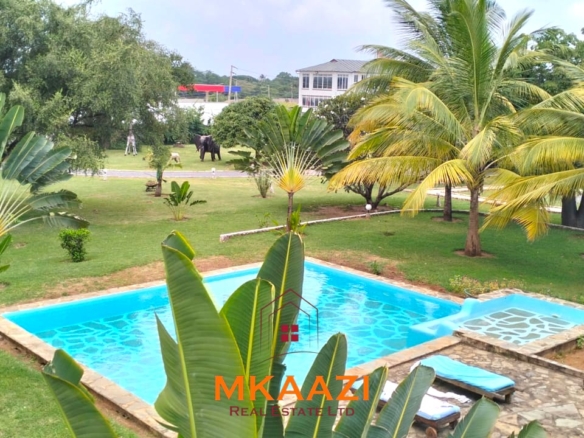 Elegant 4-bedroom all en-suite luxury villa with private swimming pool, landscaped one-acre garden, guest rooms, and entertainment area on Lamu Road, Malindi.
