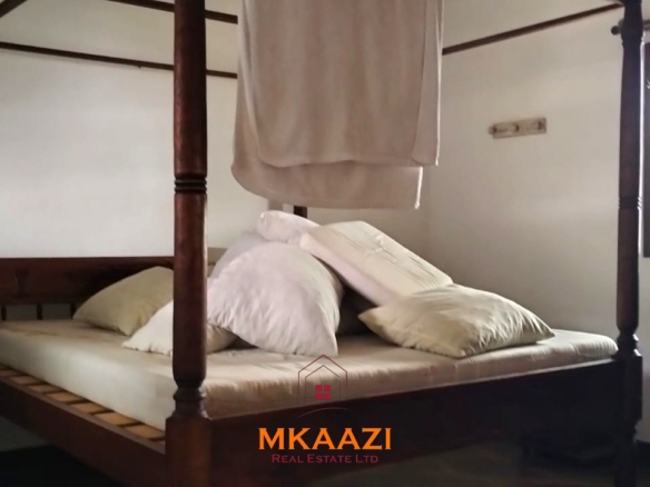 2-bedroom all en-suite Swahili villa with makuti roof, shared swimming pool, and landscaped gardens for sale on Lamu Road, Malindi.