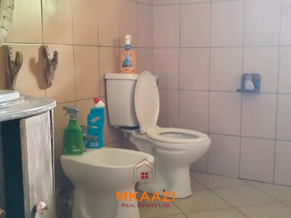 2-bedroom all en-suite Swahili villa with makuti roof, shared swimming pool, and landscaped gardens for sale on Lamu Road, Malindi.