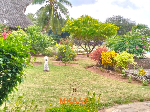 2-bedroom all en-suite Swahili villa with makuti roof, shared swimming pool, and landscaped gardens for sale on Lamu Road, Malindi.