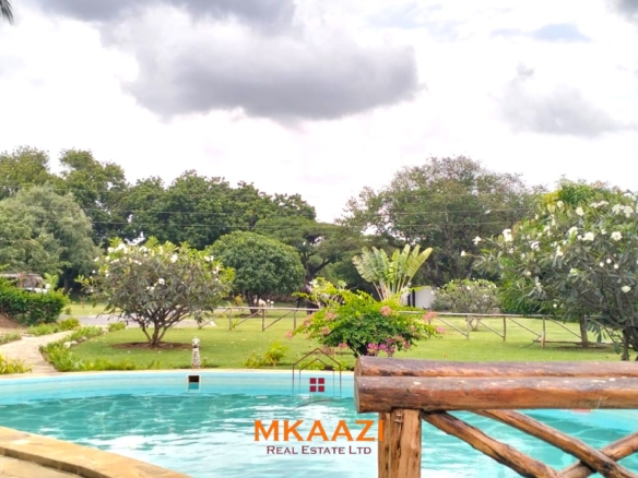 2-bedroom all en-suite Swahili villa with makuti roof, shared swimming pool, and landscaped gardens for sale on Lamu Road, Malindi.