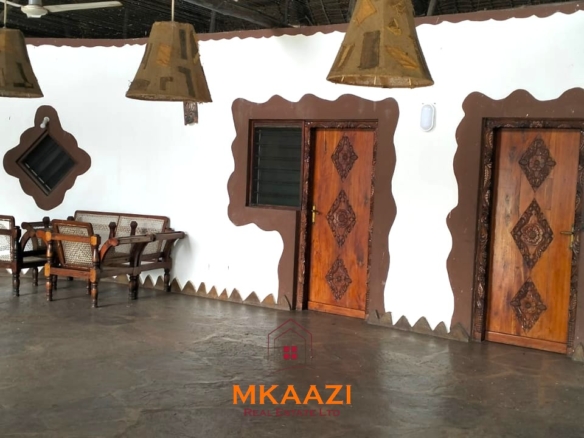 2-bedroom all en-suite Swahili villa with makuti roof, shared swimming pool, and landscaped gardens for sale on Lamu Road, Malindi.