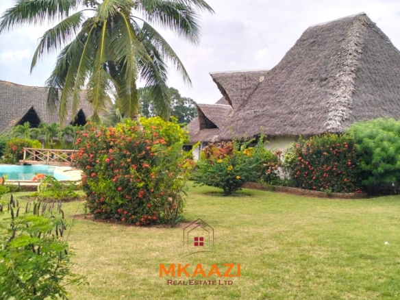 2-bedroom all en-suite Swahili villa with makuti roof, shared swimming pool, and landscaped gardens for sale on Lamu Road, Malindi.