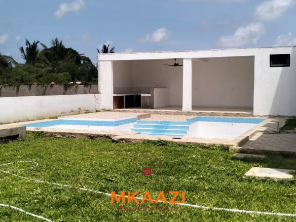 Luxury 4-bedroom villa for sale in Carolina Residence on Casuarina Road, Malindi with solar backup, swimming pool, gazebo, and ready for immediate occupancy.