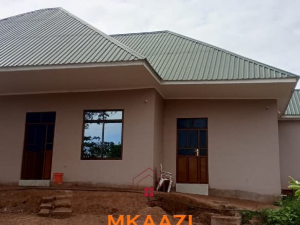 3-acre developed farm for sale in Kimashuku Mnadani, Moshi, Tanzania, featuring a farmhouse, 140-metre borehole, greenhouse, 200 apple trees, fruit trees and 5,000-litre water tank.