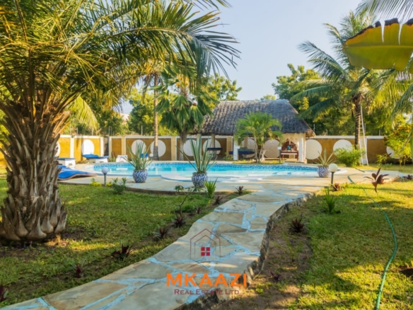 Fully furnished five-bedroom holiday home for sale in Diani on half an acre, featuring a private swimming pool and convenient access to Ukunda and the airstrip.