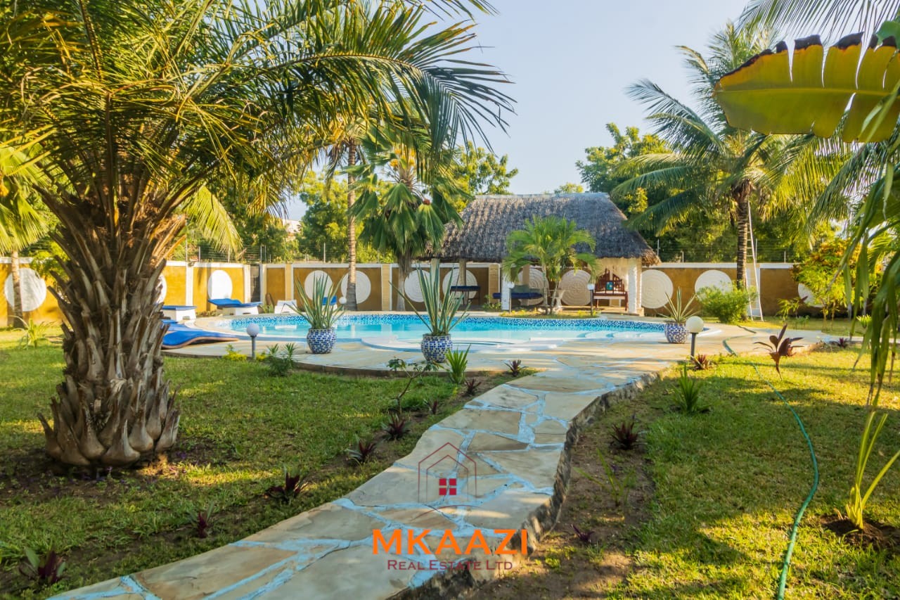 Fully furnished five-bedroom holiday home for sale in Diani on half an acre, featuring a private swimming pool and convenient access to Ukunda and the airstrip.