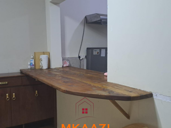 Fully furnished 3-bedroom ground-floor apartment for sale at Palm Ridge, Vipingo, featuring two bathrooms, swimming pool, green parks, parking, and 24/7 security.