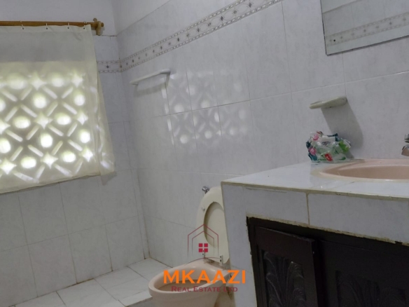 Half-acre property for sale off Kanani Road in Watamu with a 2-bedroom house, 1-bedroom SQ and three unfinished rental units near Watamu Mall.