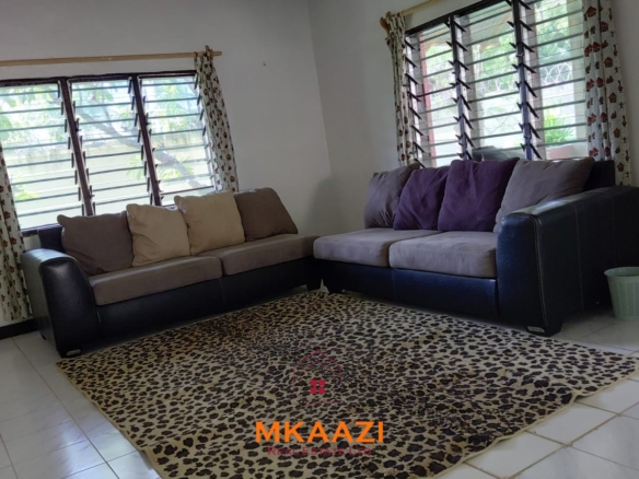 Half-acre property for sale off Kanani Road in Watamu with a 2-bedroom house, 1-bedroom SQ and three unfinished rental units near Watamu Mall.