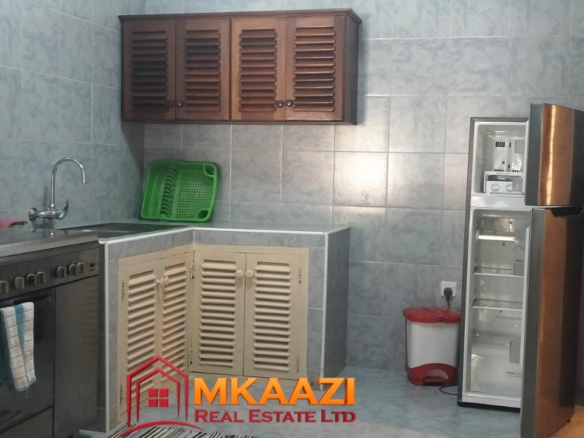 Self-catering kitchen in a fully furnished 2-bedroom apartment at Mango Plaza Apartments.