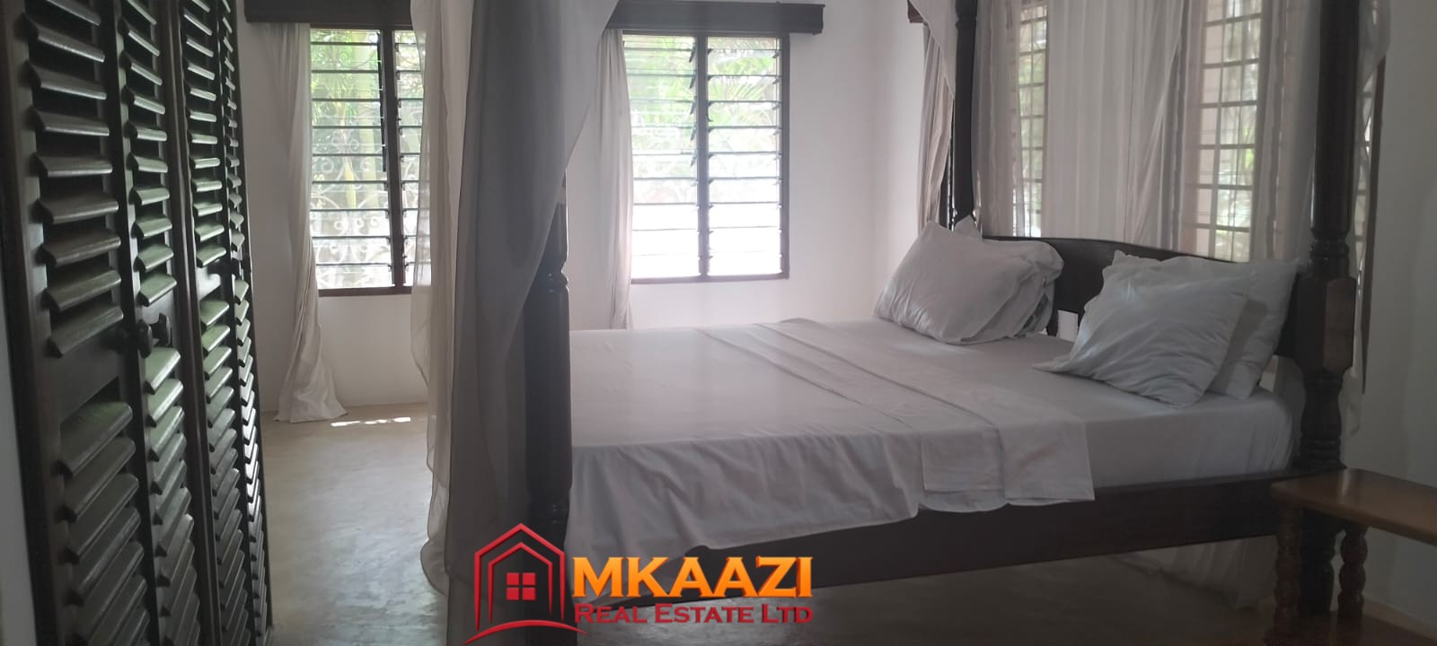 Mango Plaza 1br (13) Tastefully furnished bedroom in a modern apartment at Mango Plaza Apartments.