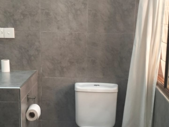 Contemporary bathroom fittings in a modern 2-bedroom apartment available for short- and long-term rental.