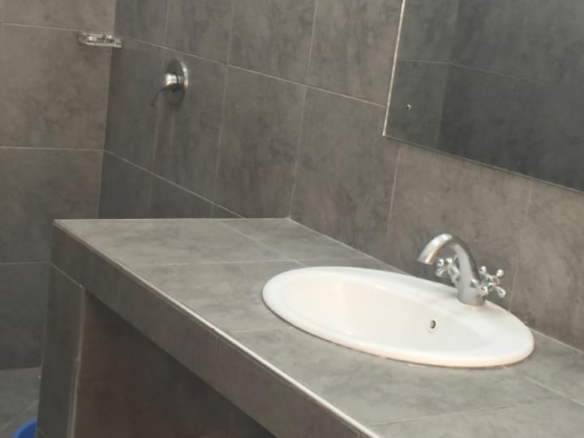 Modern toilet and bathroom facilities in a spacious 2-bedroom apartment at Mango Plaza Apartments.