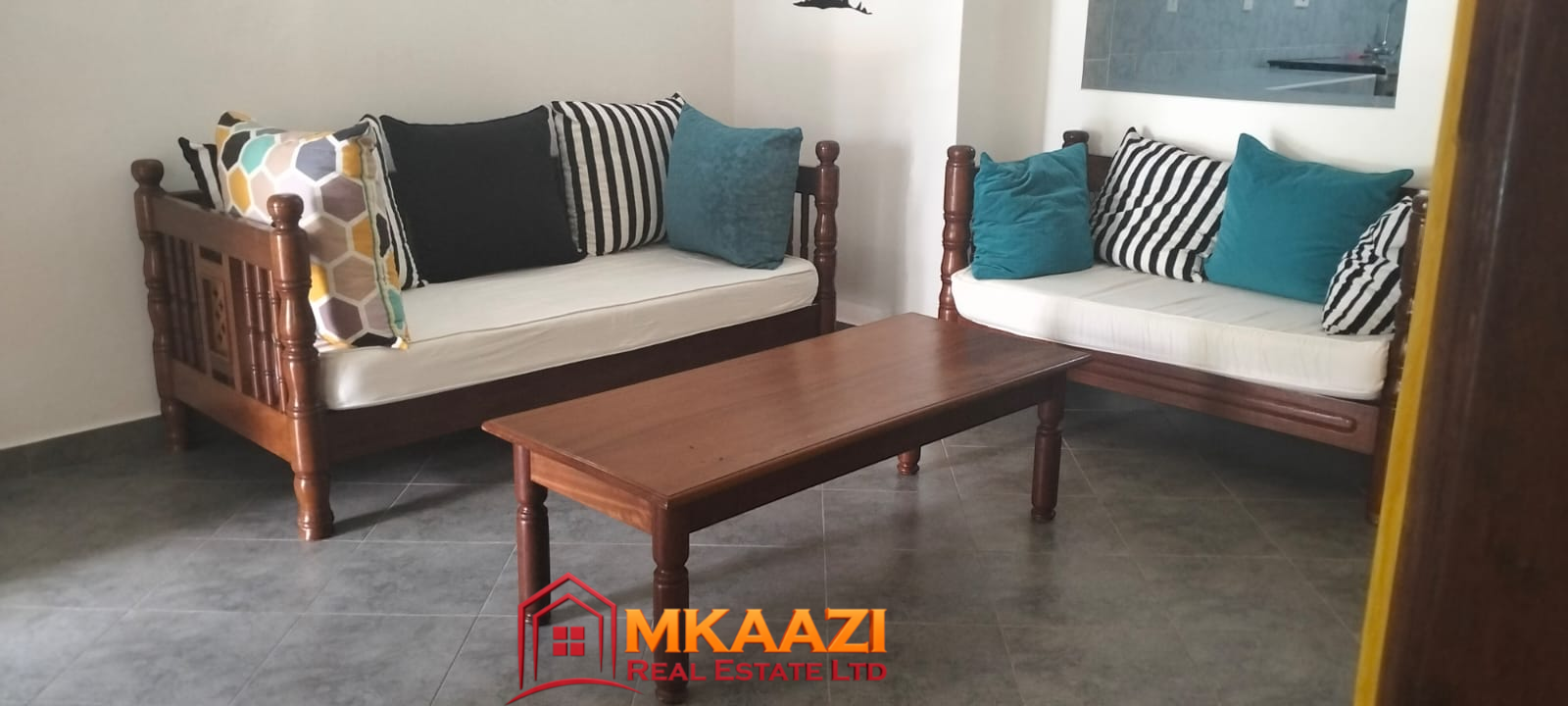 Mango Plaza 1br (8) Spacious furnished living room in a modern 2-bedroom apartment at Mango Plaza Apartments.