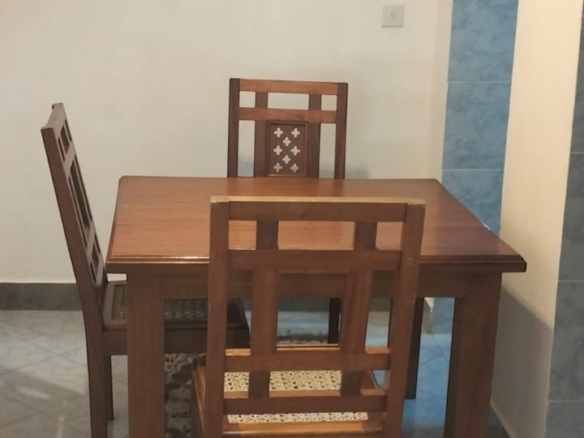 Furnished dining area in a modern 2-bedroom apartment at Mango Plaza Apartments.